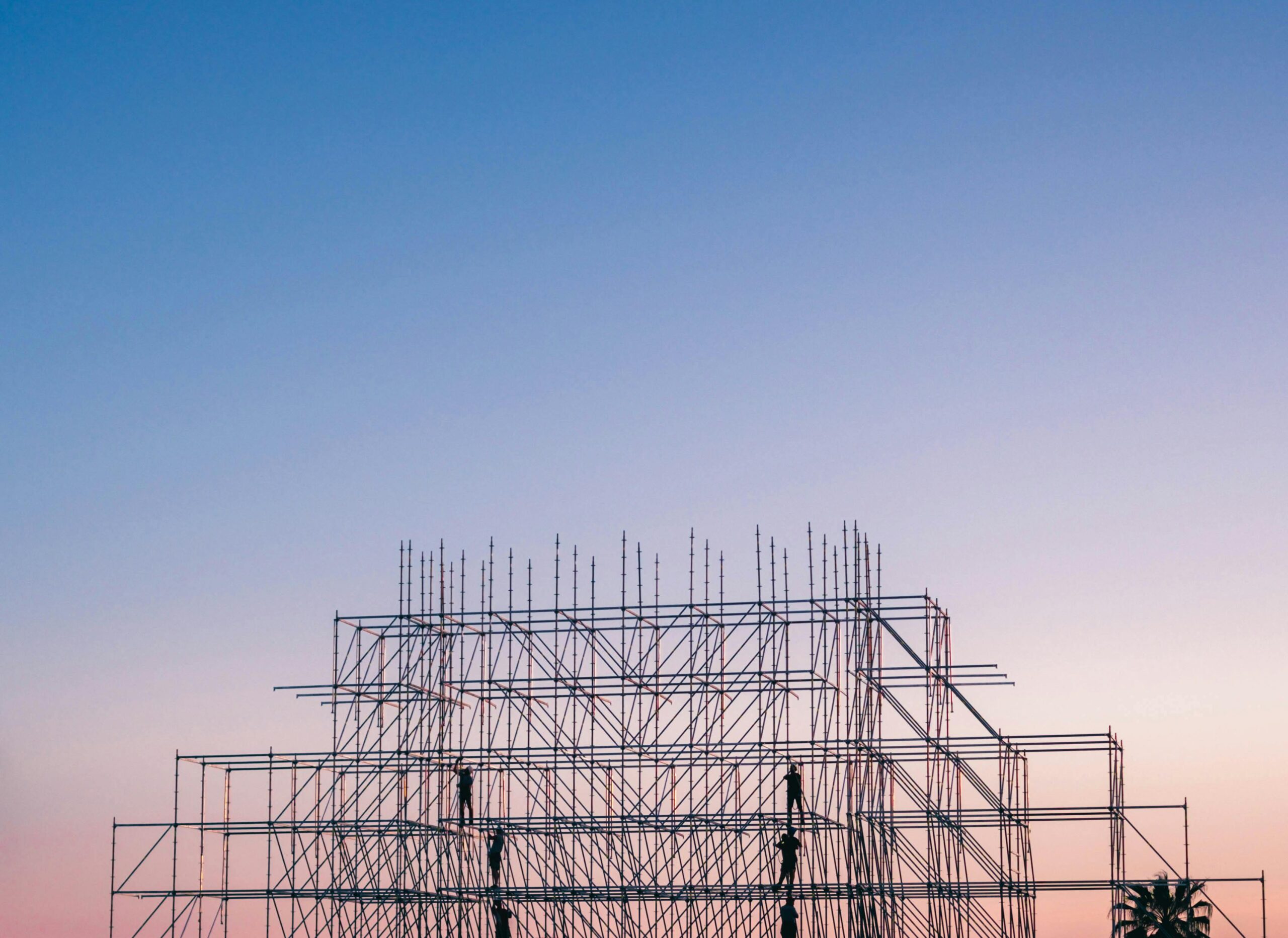 A silhouetted structure against a colorful sunset, showcasing industrial scaffolding in Sochi, Russia.